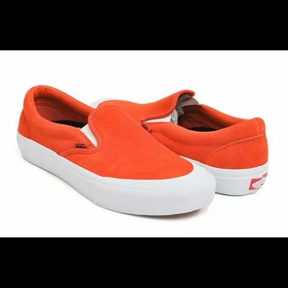 orange and white slip on vans